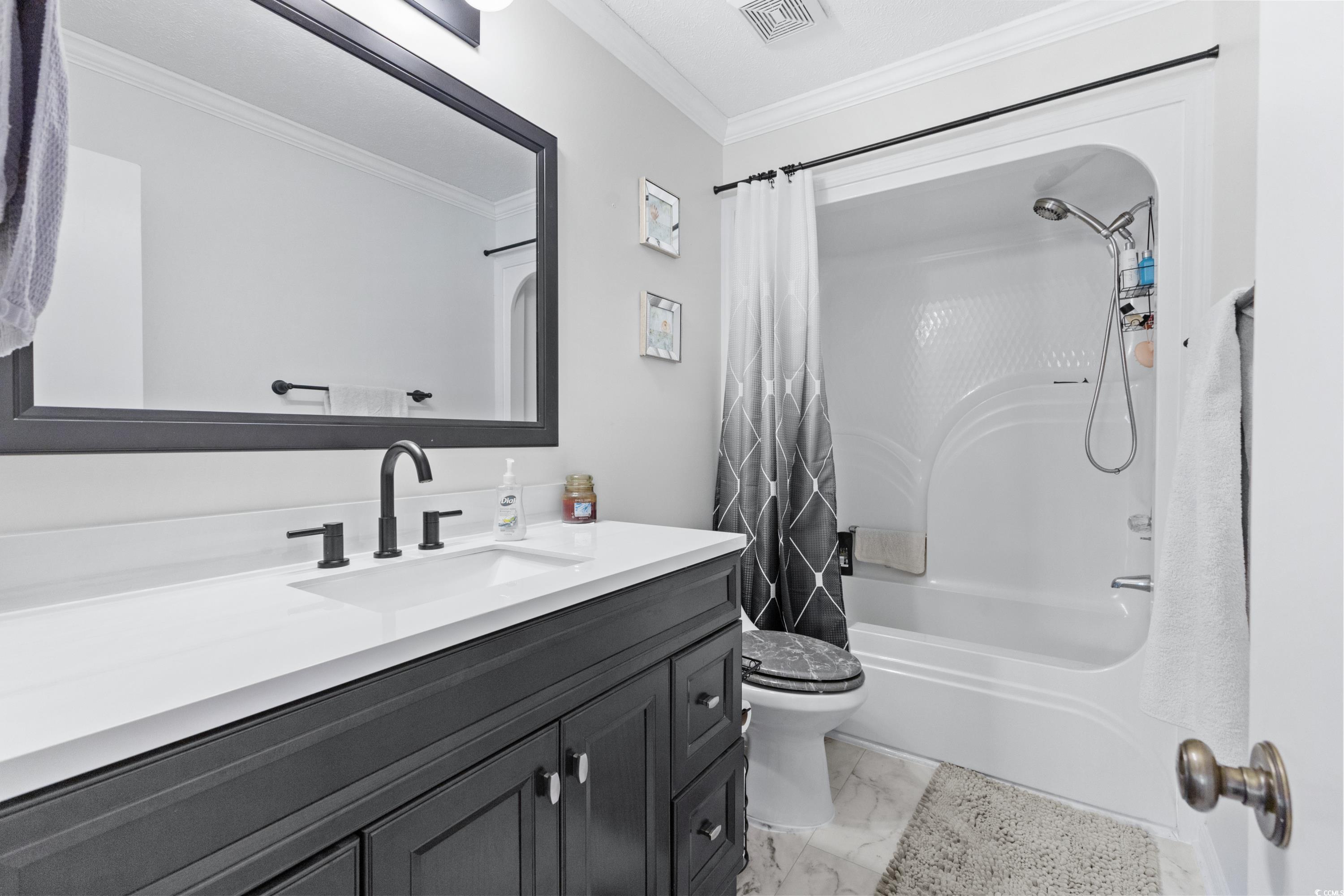1869 Meadowood Lane Longs, SC 29568 - Photo 20 of 37 Full bathroom with vanity, marble finish floor, toilet, ornamental molding, and visible vents