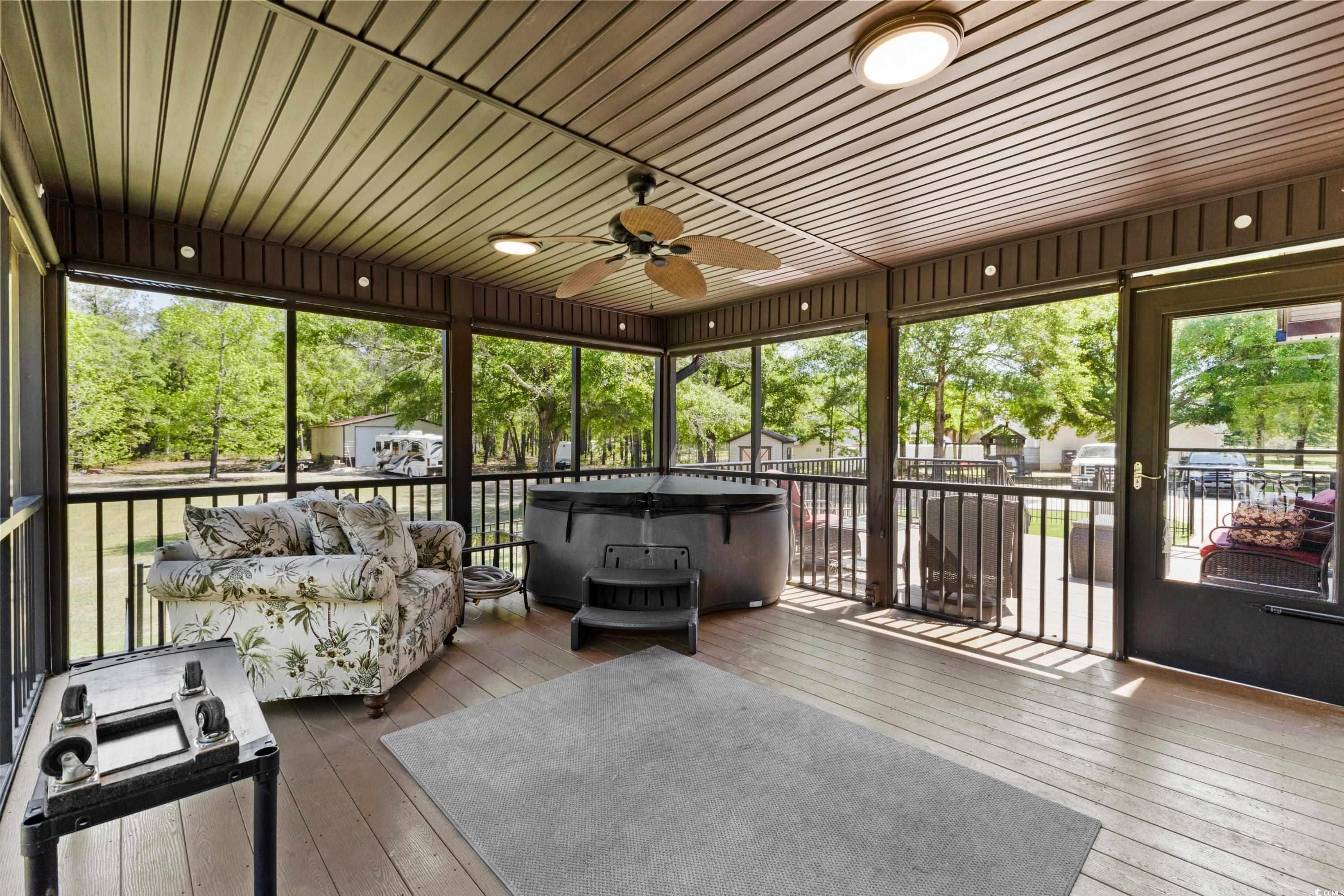 1869 Meadowood Lane Longs, SC 29568 - Photo 23 of 37 Sunroom / solarium with an outdoor living space, a hot tub, and ceiling fan