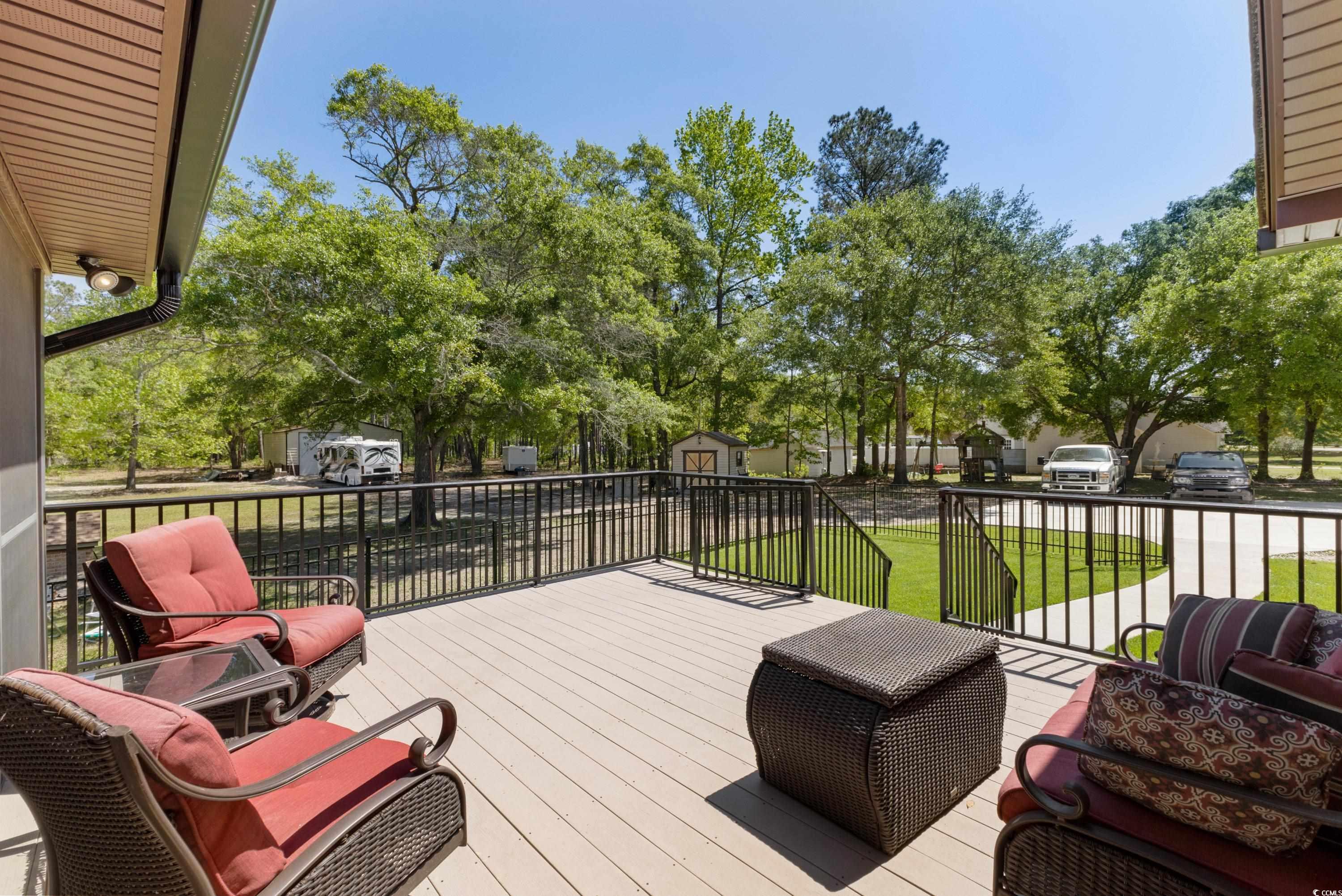 1869 Meadowood Lane Longs, SC 29568 - Photo 25 of 37 Deck featuring an outbuilding, a yard, and a shed