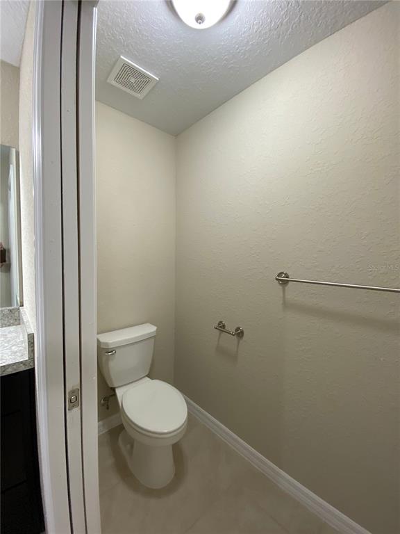 16767 Southwest 21st Terrace Road Ocala, FL 34473 - Photo 18 of 30 a white toilet sitting next to a shower