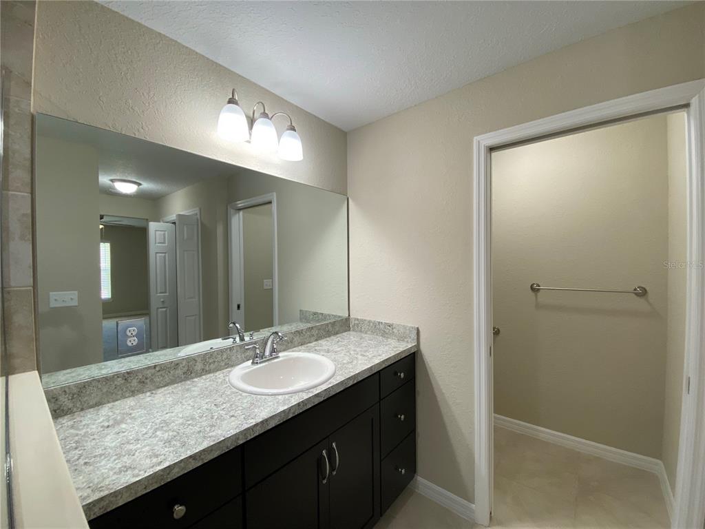 16767 Southwest 21st Terrace Road Ocala, FL 34473 - Photo 20 of 30 a bathroom with double sink and a mirror