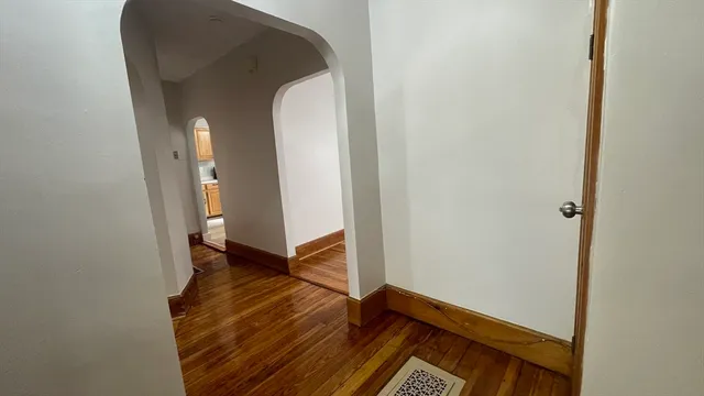 a view of a room with wooden floor