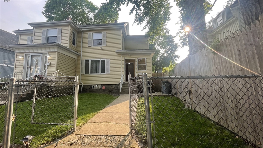 13 Whitman Street, Unit B Boston, MA 02124 - Photo 2 of 25 a view of a house with a backyard