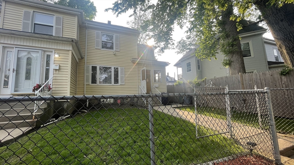 13 Whitman Street, Unit B Boston, MA 02124 - Photo 3 of 25 a front view of a house with a yard