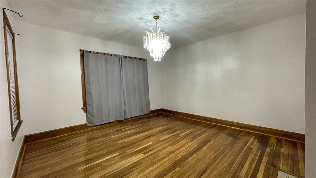 13 Whitman Street, Unit B Boston, MA 02124 - Photo 6 of 25 a view of an empty room with wooden floor