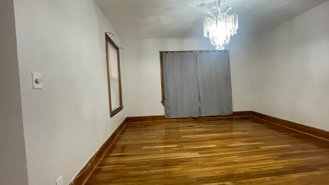 a view of a room with window and chandelier