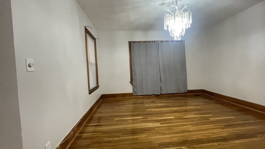 13 Whitman Street, Unit B Boston, MA 02124 - Photo 7 of 25 a view of a room with window and chandelier