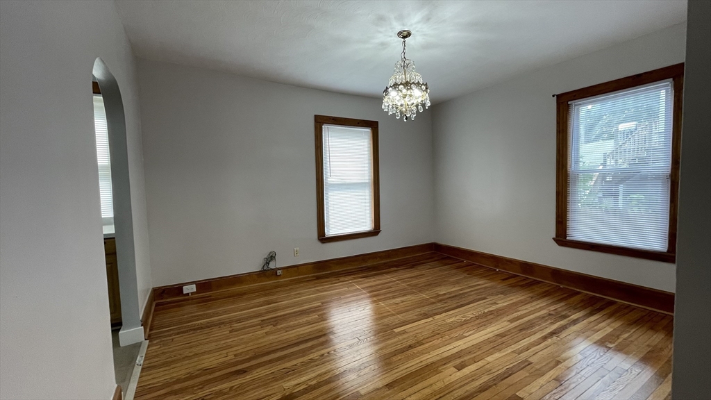 13 Whitman Street, Unit B Boston, MA 02124 - Photo 8 of 25 a view of an empty room with window and wooden floor