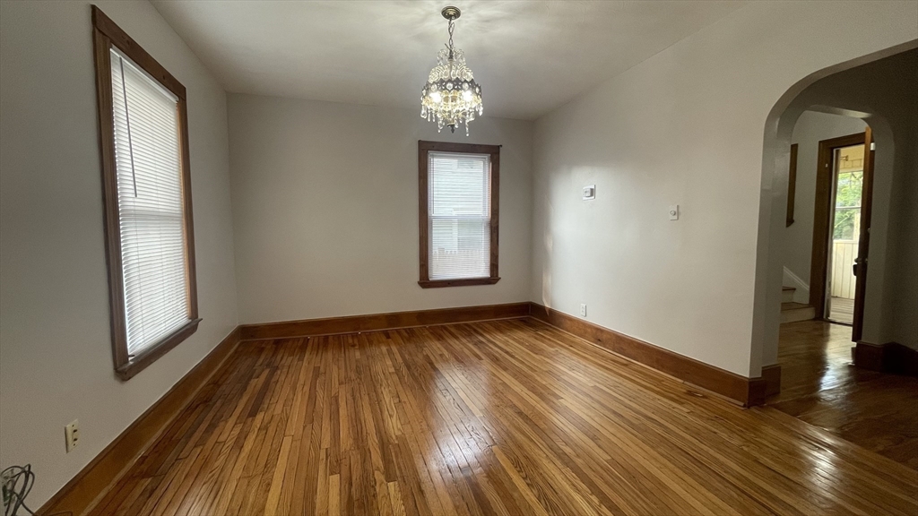 13 Whitman Street, Unit B Boston, MA 02124 - Photo 9 of 25 a view of a room with wooden floor and windows