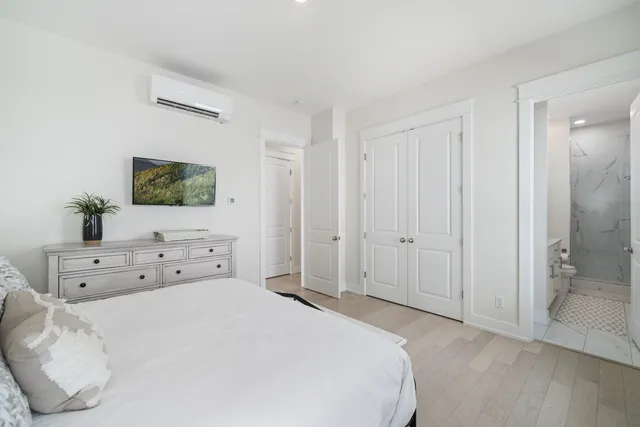 a bedroom with a bed and a large mirror