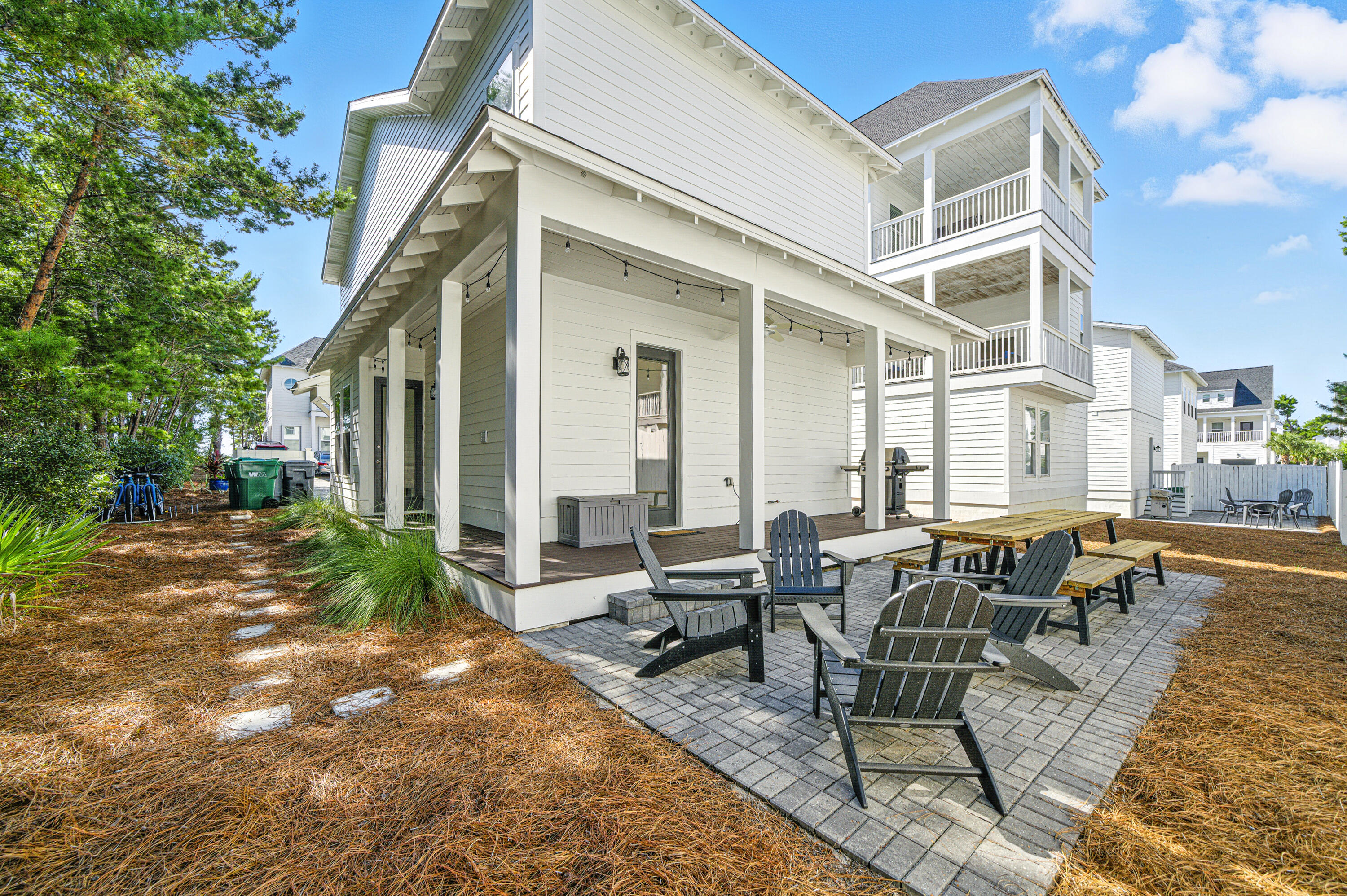97 Beach View Drive Inlet Beach, FL 32461 - Photo 3 of 57 a view of a patio with couches table and chairs and floor to ceiling window with plants and trees