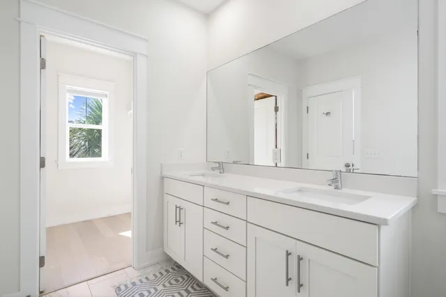 a bathroom with a granite countertop sink mirror and shower