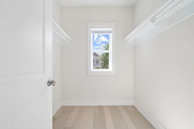 a bedroom with two beds and a window
