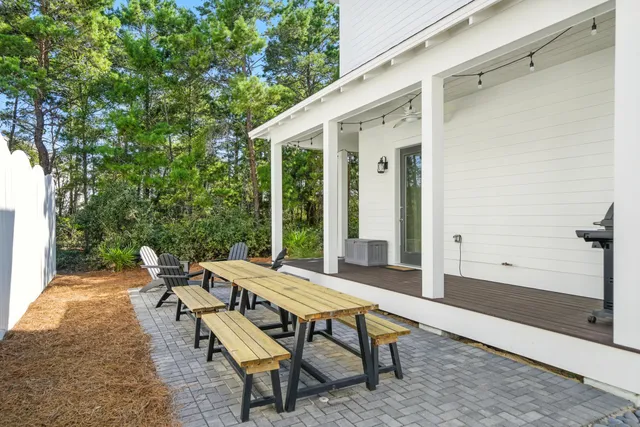 a backyard of a house with table and chairs