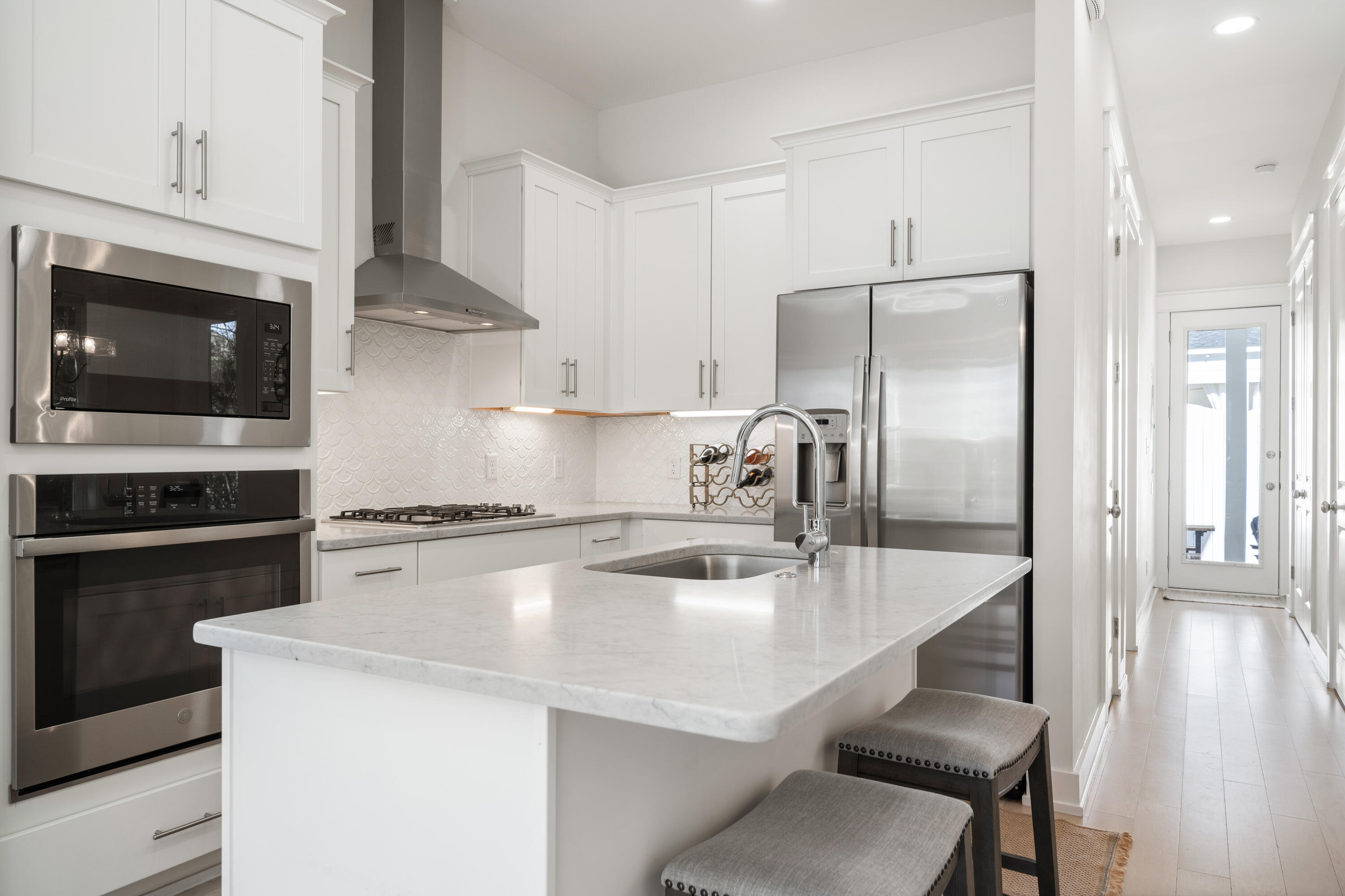 97 Beach View Drive Inlet Beach, FL 32461 - Photo 7 of 57 a kitchen with a sink a microwave a refrigerator and cabinets