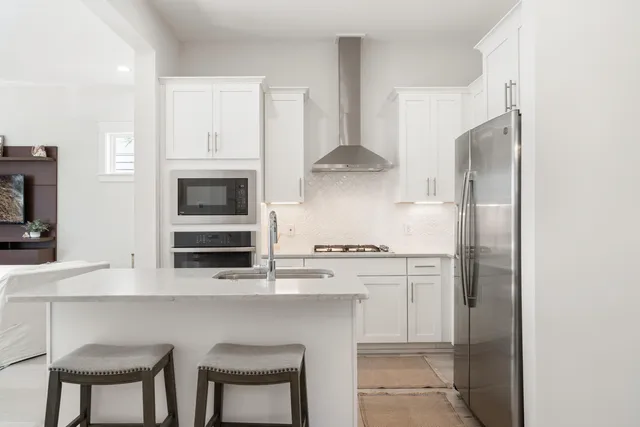 a kitchen with stainless steel appliances a stove microwave and cabinets