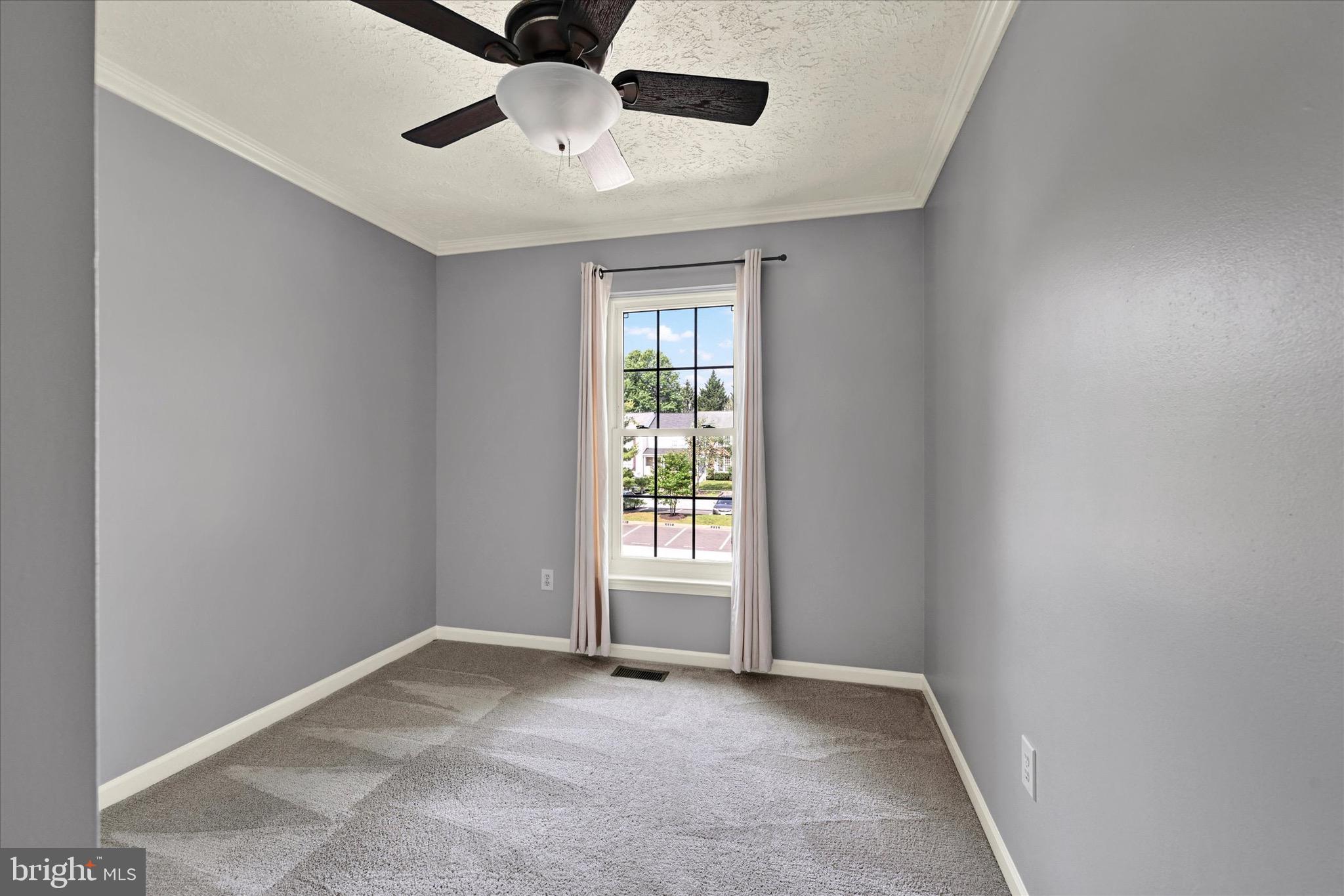 6119 Starburn Path Columbia, MD 21045 - Photo 15 of 28 an empty room with windows and ceiling fan