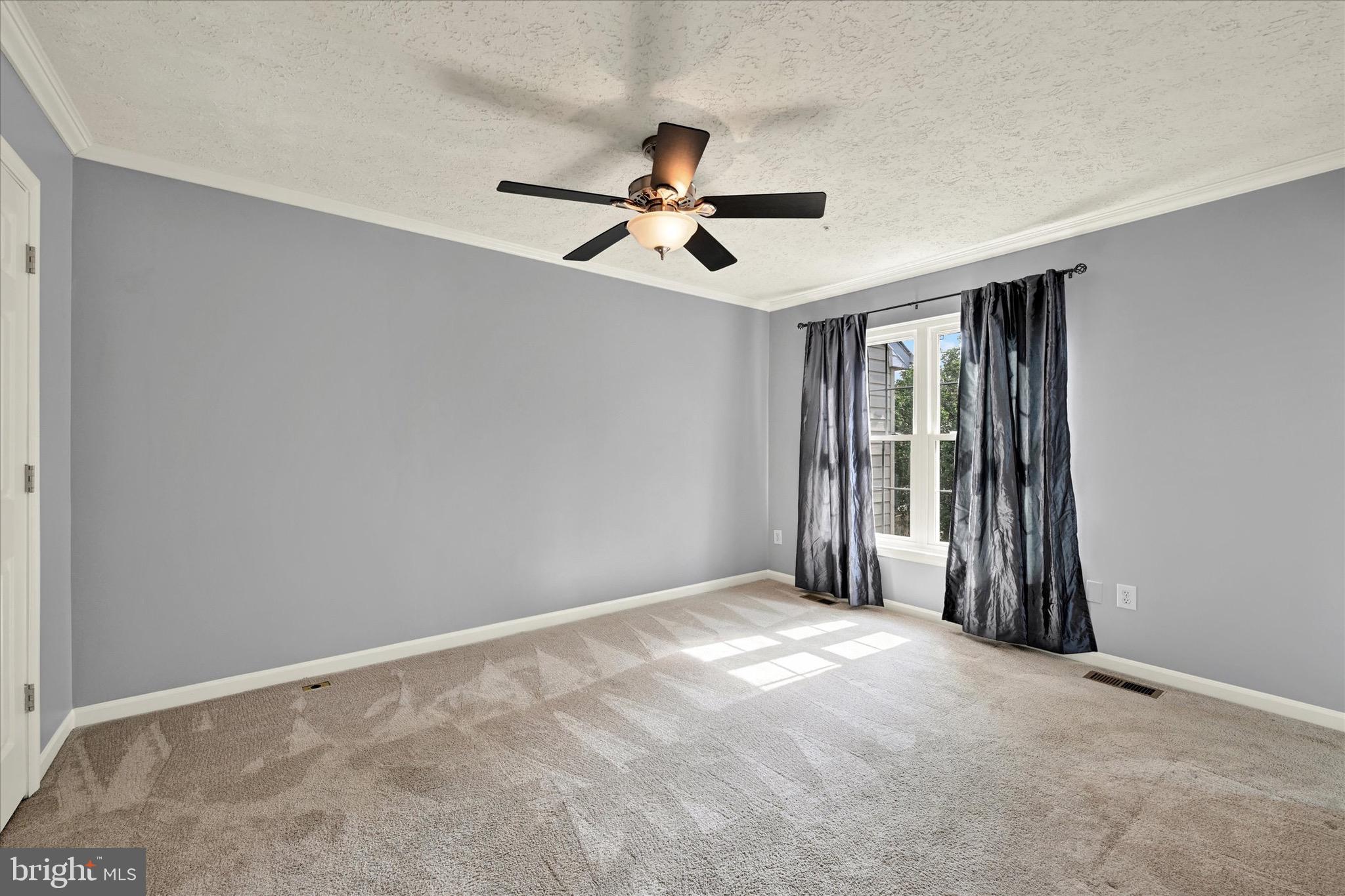 6119 Starburn Path Columbia, MD 21045 - Photo 18 of 28 a view of a room with a ceiling fan and a window