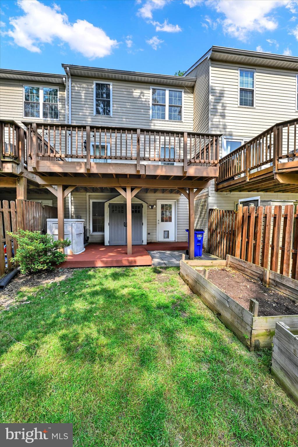 6119 Starburn Path Columbia, MD 21045 - Photo 27 of 28 a view of a house with a yard and deck