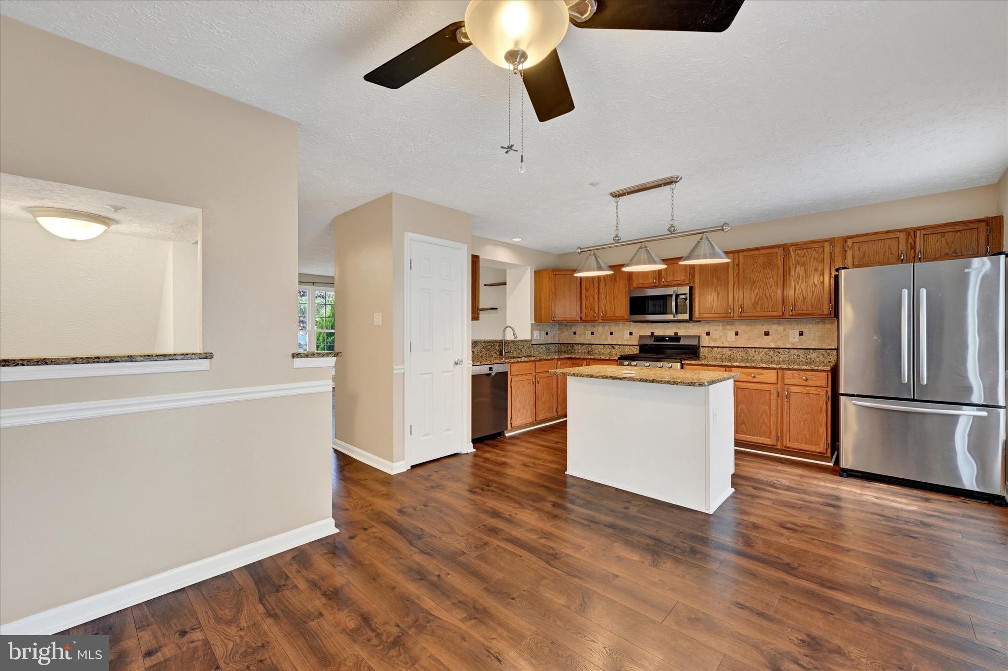 6119 Starburn Path Columbia, MD 21045 - Photo 7 of 28 a kitchen with stainless steel appliances a refrigerator and a stove top oven