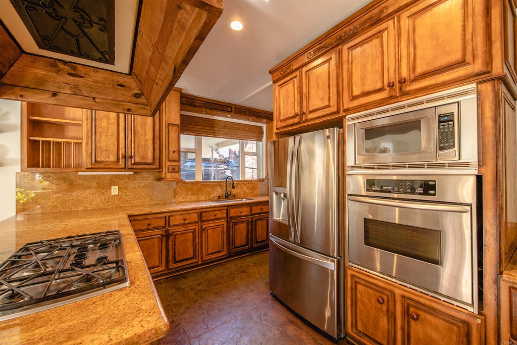 3209 James Drive Carlsbad, CA 92008 - Photo 13 of 65 a kitchen with stainless steel appliances granite countertop a stove and a refrigerator