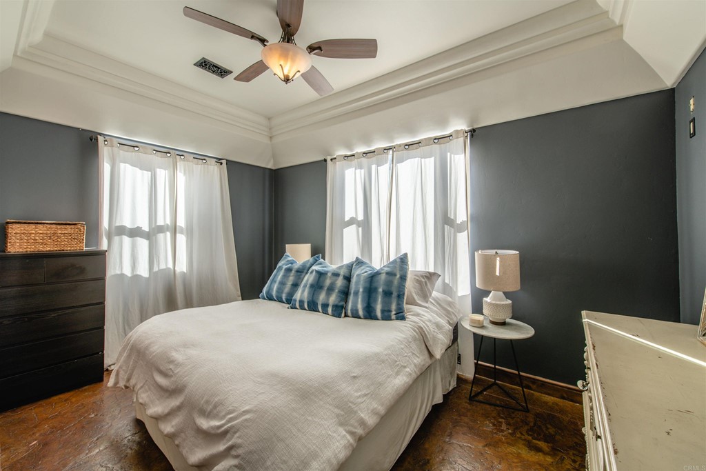 3209 James Drive Carlsbad, CA 92008 - Photo 30 of 65 a bedroom with a bed and a chandelier