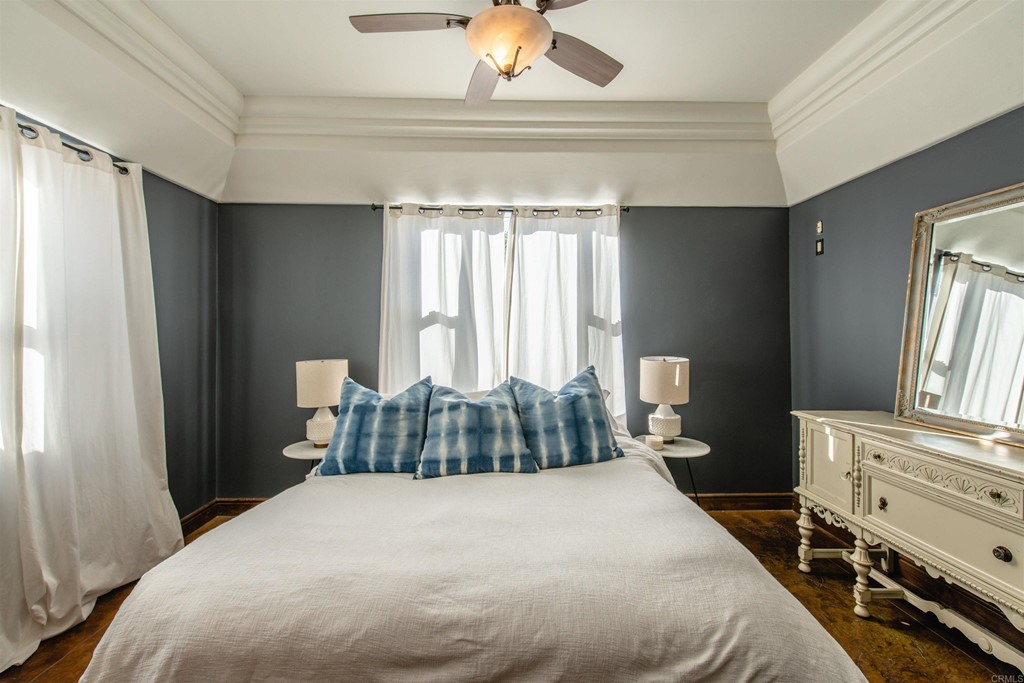 3209 James Drive Carlsbad, CA 92008 - Photo 31 of 65 a bedroom with a bed and a chandelier