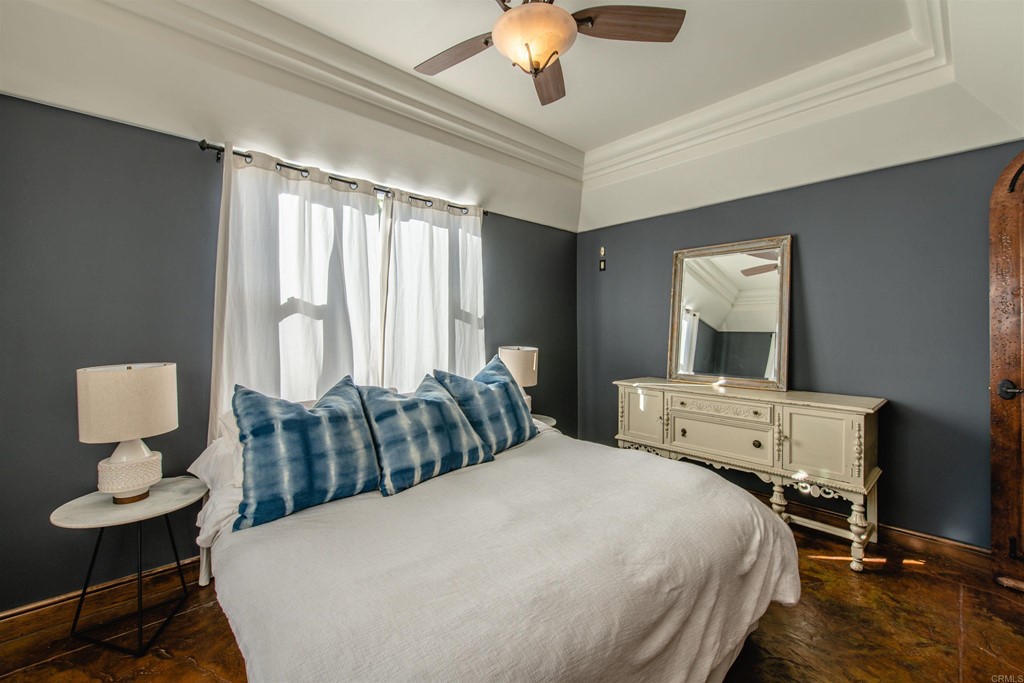 3209 James Drive Carlsbad, CA 92008 - Photo 32 of 65 a bedroom with a bed and a chandelier