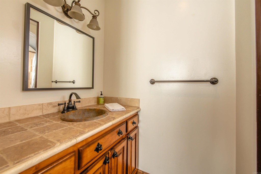 3209 James Drive Carlsbad, CA 92008 - Photo 33 of 65 a bathroom with a sink and a mirror