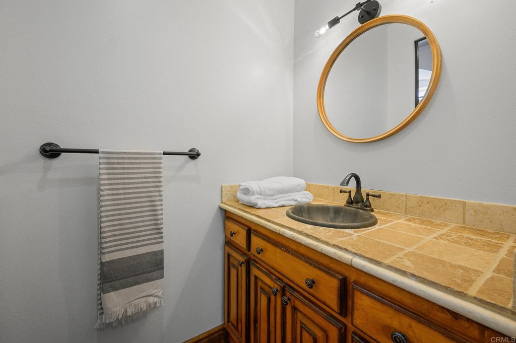 3209 James Drive Carlsbad, CA 92008 - Photo 36 of 65 a bathroom with a sink and a mirror