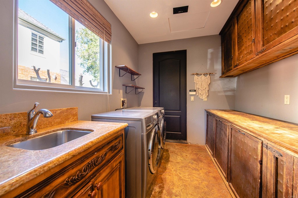 3209 James Drive Carlsbad, CA 92008 - Photo 37 of 65 a utility room with sink a washer and dryer