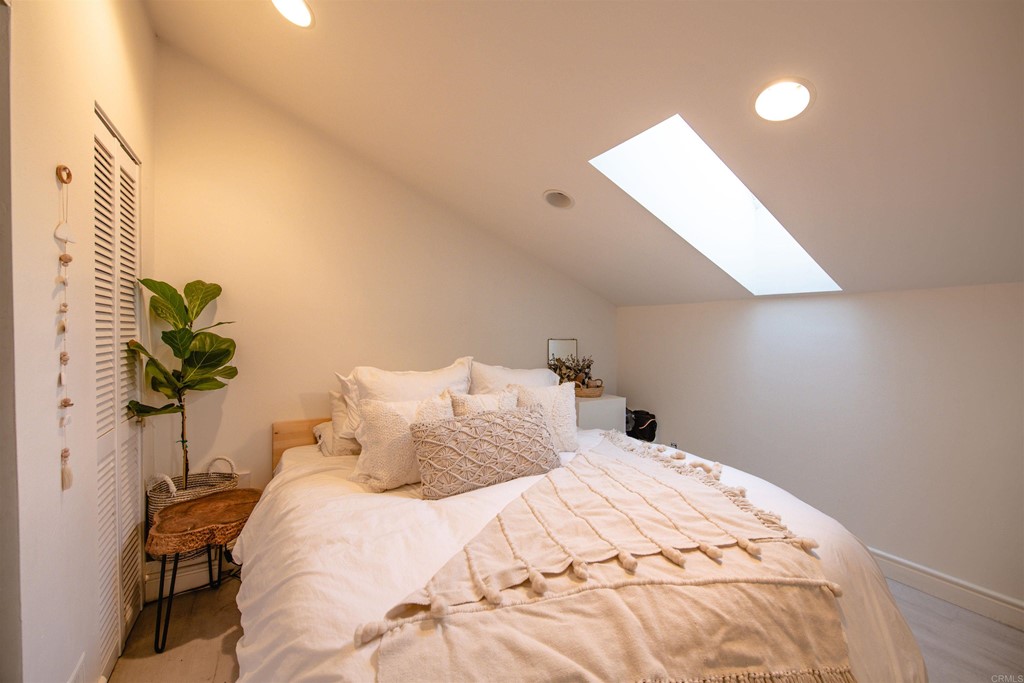 3209 James Drive Carlsbad, CA 92008 - Photo 41 of 65 a bedroom with a bed and a potted plant