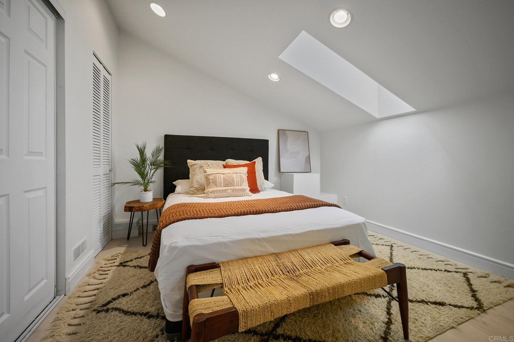 3209 James Drive Carlsbad, CA 92008 - Photo 42 of 65 a bedroom with a bed and wooden floor