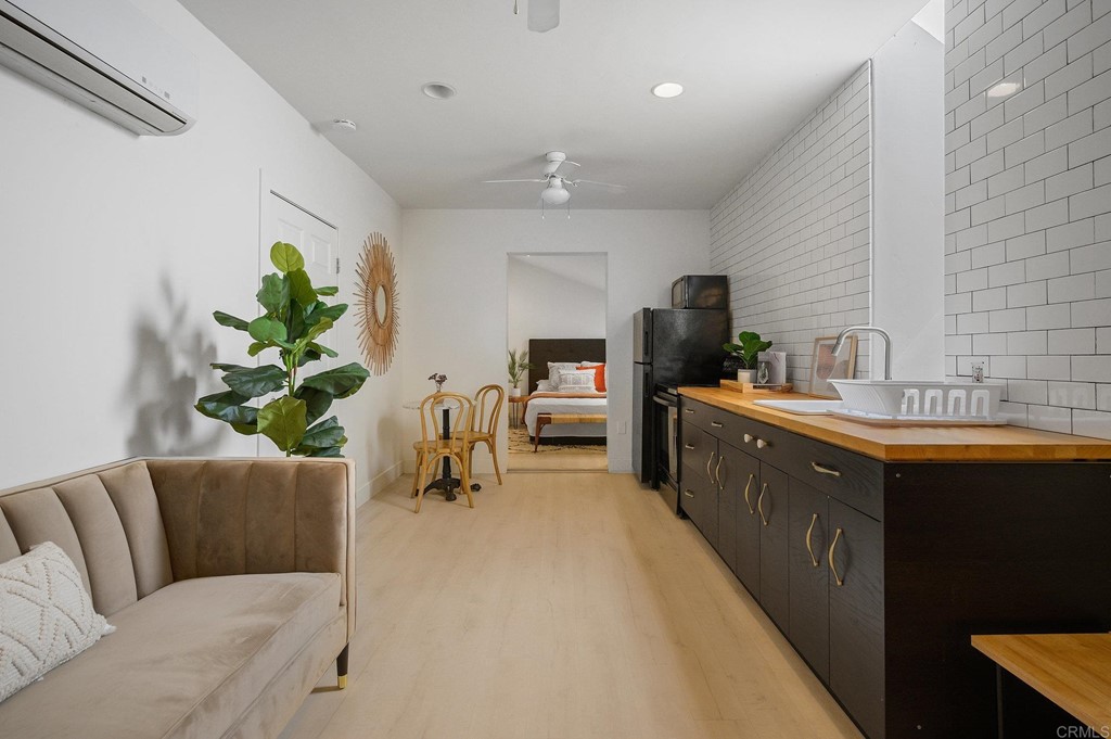 3209 James Drive Carlsbad, CA 92008 - Photo 45 of 65 a living room with stainless steel appliances kitchen island granite countertop furniture a sink a counter top space