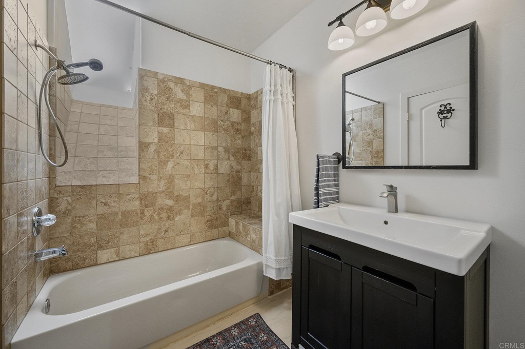 3209 James Drive Carlsbad, CA 92008 - Photo 46 of 65 a bathroom with a sink vanity tub shower and a mirror