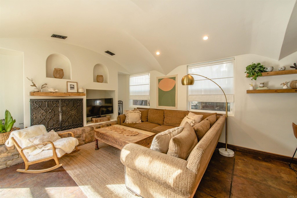 3209 James Drive Carlsbad, CA 92008 - Photo 10 of 65 a living room with furniture kitchen view and a fireplace