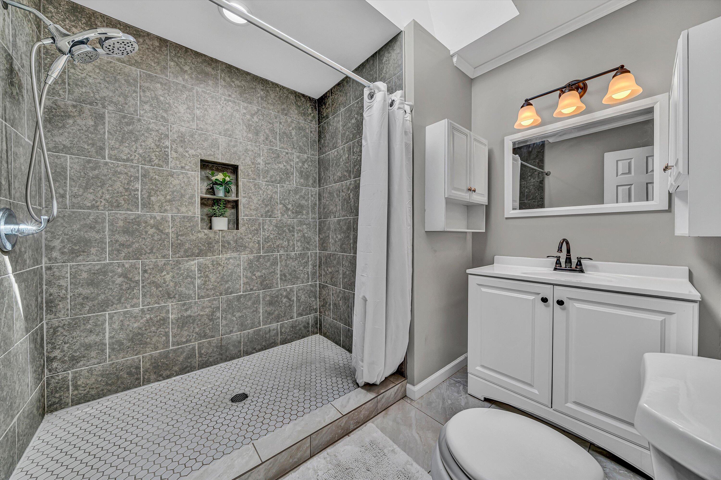 4070 Pitzer Road Roanoke, VA 24014 - Photo 11 of 25 a bathroom with a sink toilet and shower