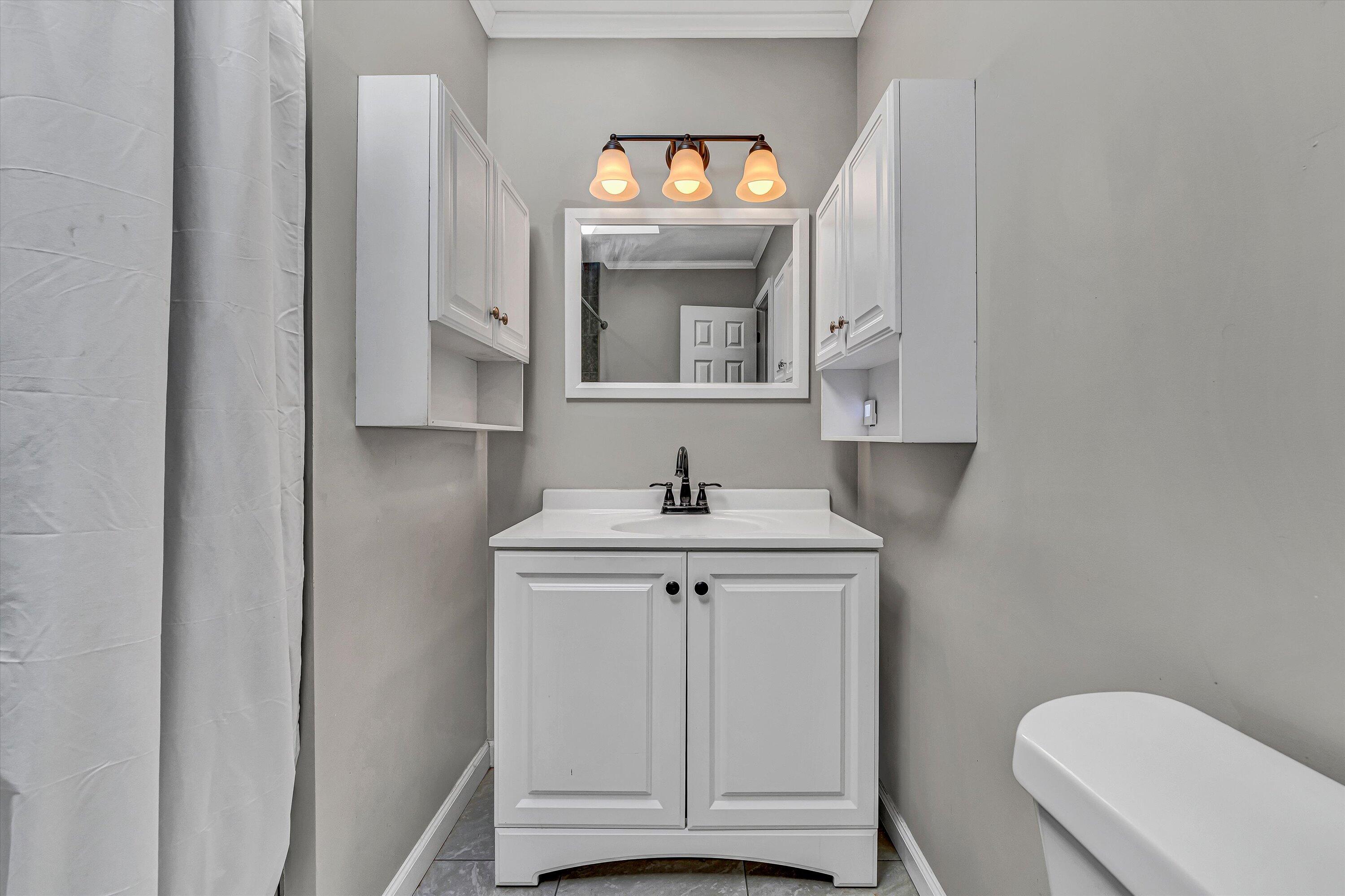 4070 Pitzer Road Roanoke, VA 24014 - Photo 12 of 25 a bathroom with a toilet a sink and mirror