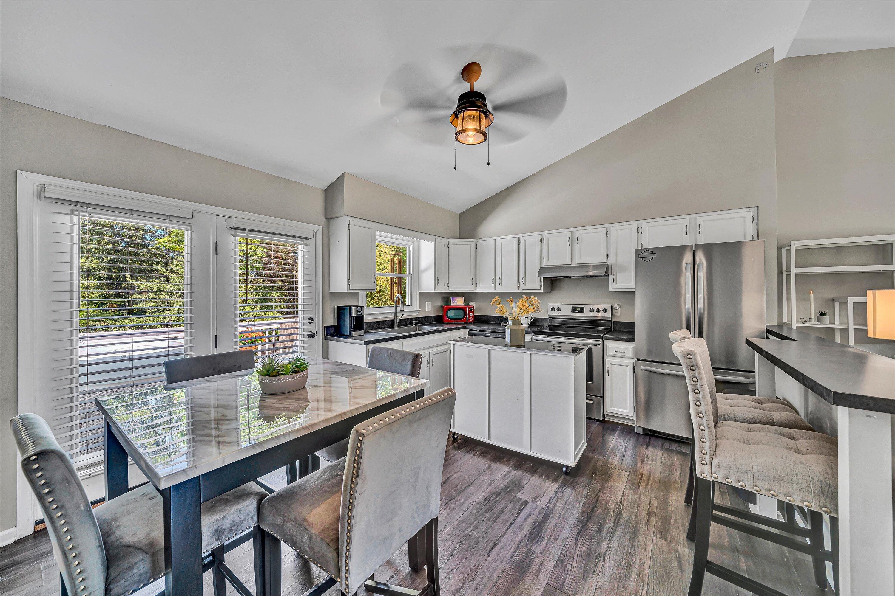 4070 Pitzer Road Roanoke, VA 24014 - Photo 6 of 25 a kitchen with a dining table chairs refrigerator and cabinets