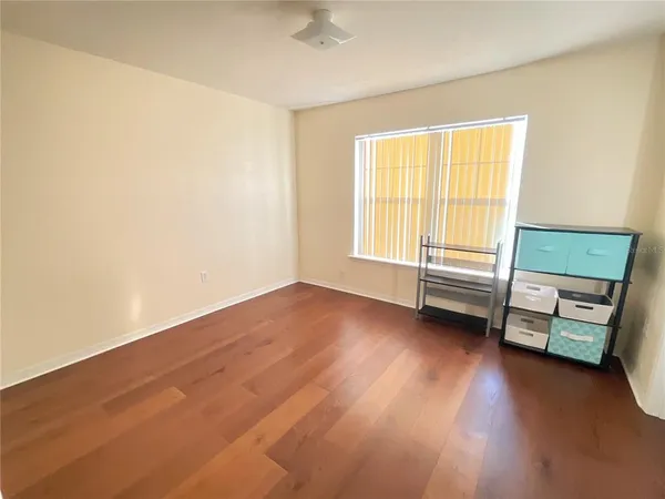 a view of room with window and wooden floor