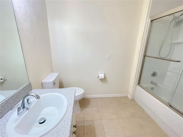 a bathroom with a sink and mirror with toilet