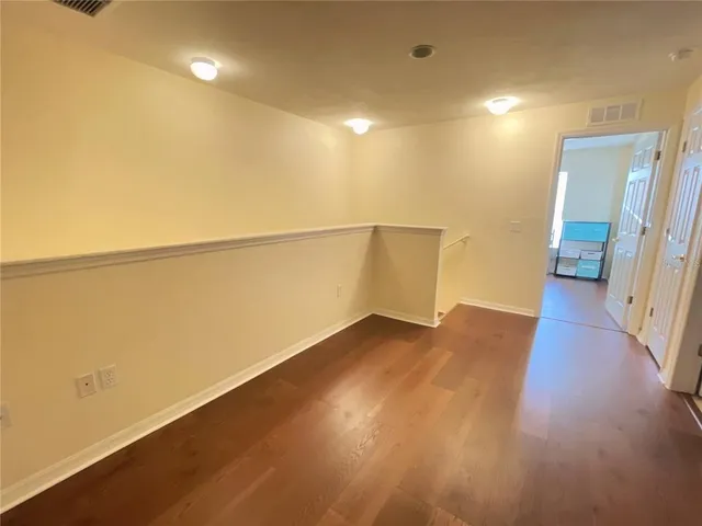 a view of a room with wooden floor