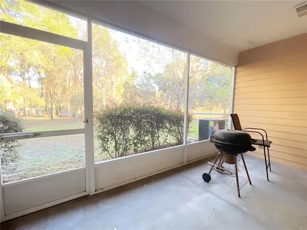 a view of a room with furniture and a large window