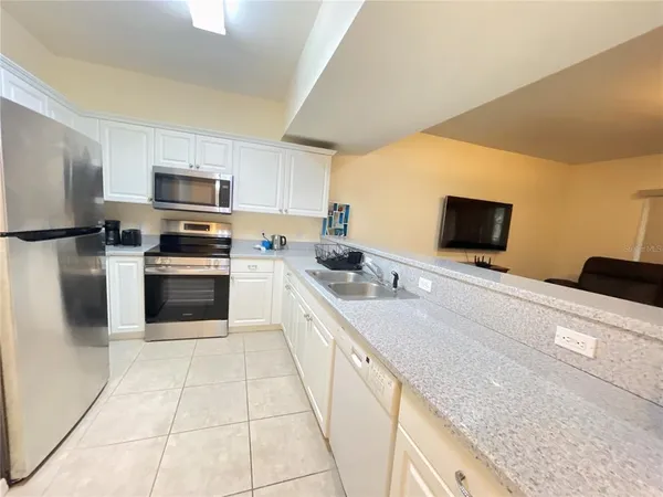 a large kitchen with cabinets stainless steel appliances and a counter space