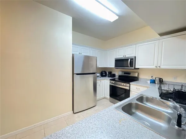a kitchen with a refrigerator stove and microwave