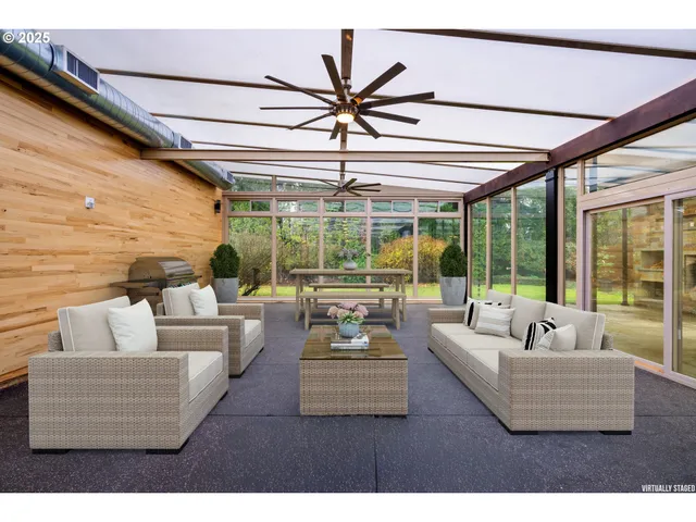 a living room with furniture and large windows