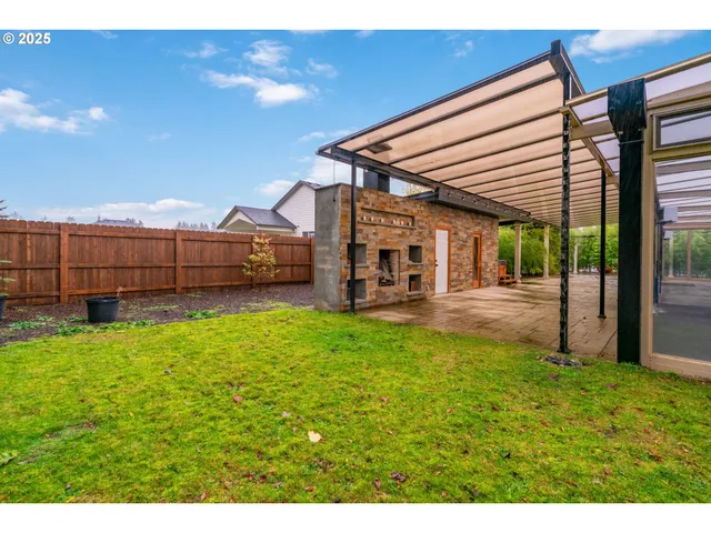 a view of a backyard with a garden and deck