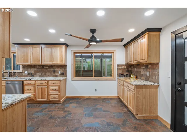 a kitchen with granite countertop a stove top oven sink and cabinets