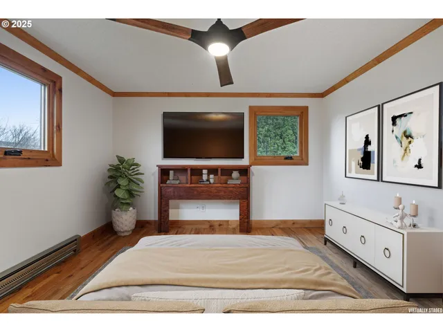 a bedroom with furniture and a flat screen tv