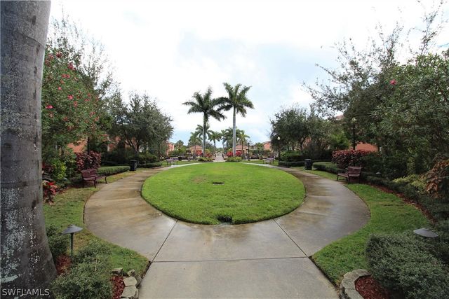 a view of swimming pool with palm trees